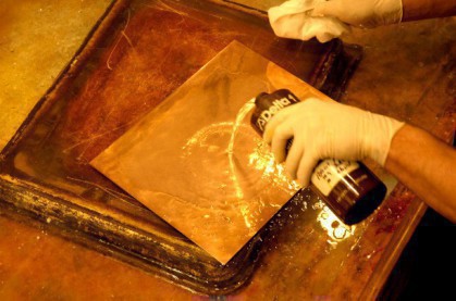 Tarnish is removed from the plate with a dilute acid.
