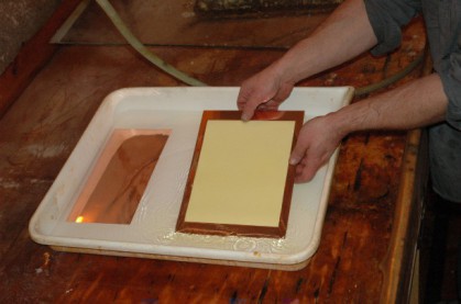 Tissue is centred on the plate and the plate is removed to a firm surface.