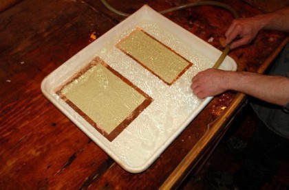 The plates are placed in a tray of hot water.